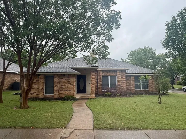 Home exterior before — weathered siding and trim